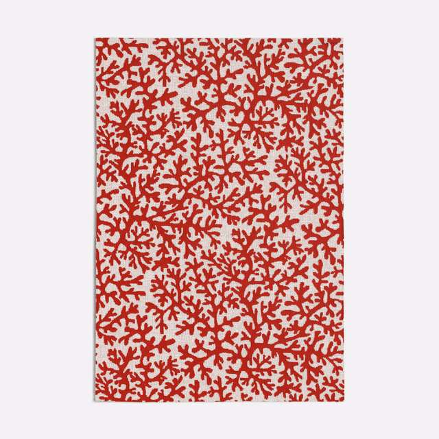 Dense deep red coral branches scattered across a pale ivory fabric ground