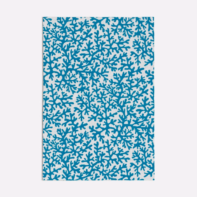 Dense cool turquoise coral branches scattered across a pale smooth fabric ground