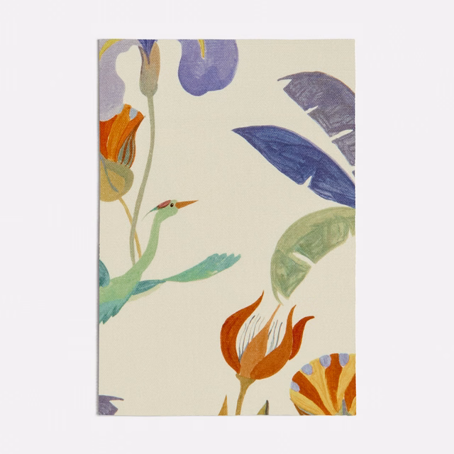 Cream fabric with seafoam foliage, purple leaves, orange flowers, and a small bird.