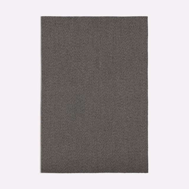 Charcoal grey fabric with a fine peppered diagonal weave and subtly mottled surface
