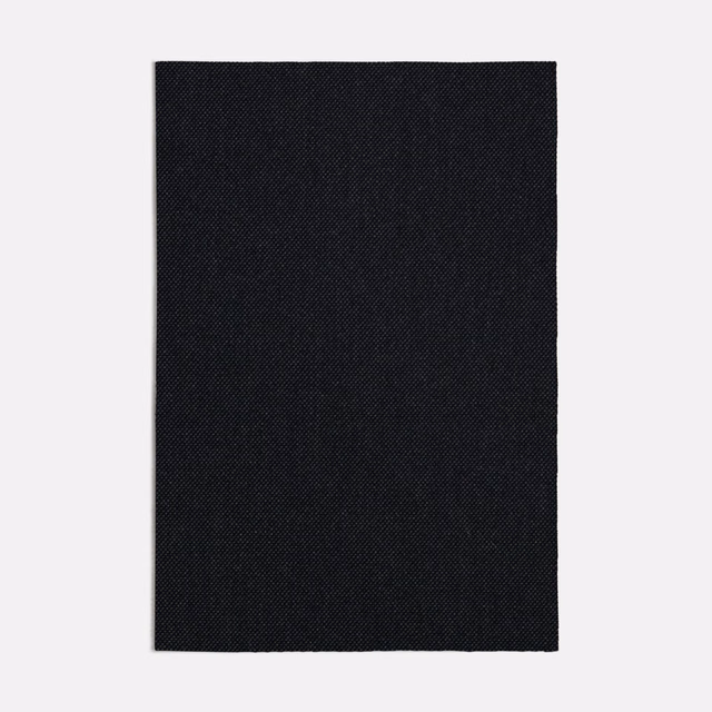 Near-black charcoal fabric with a fine, tightly woven diagonal-textured surface