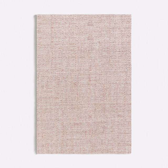 Close view of finely woven muted ash-pink textile with a softly flecked surface