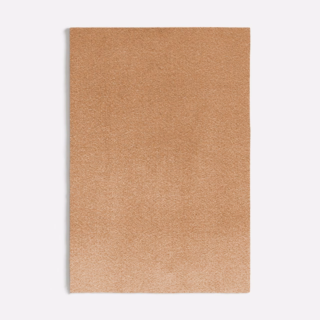 Muted peach-pink plain fabric swatch with a fine softly varied woven texture
