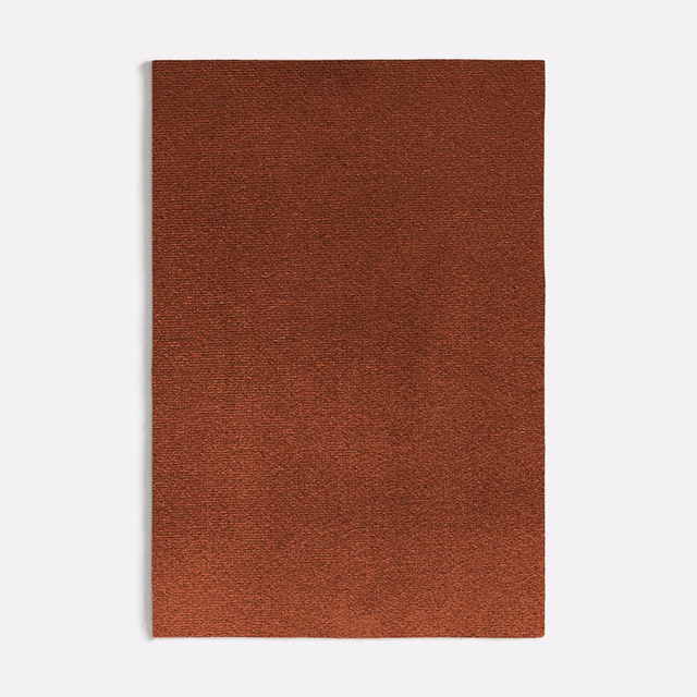 Close-up of warm red-brown Augusta Terracotta fabric with a fine, subtly grainy weave