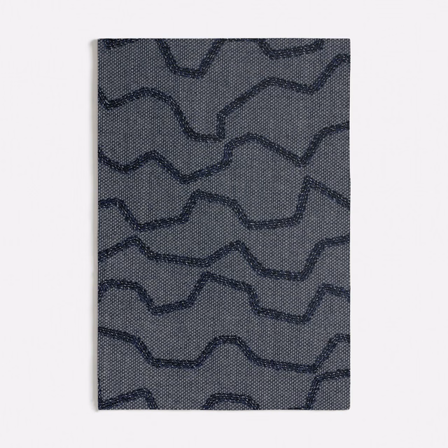 Cool blue-grey woven swatch with dark navy irregular wave lines and dotted texture
