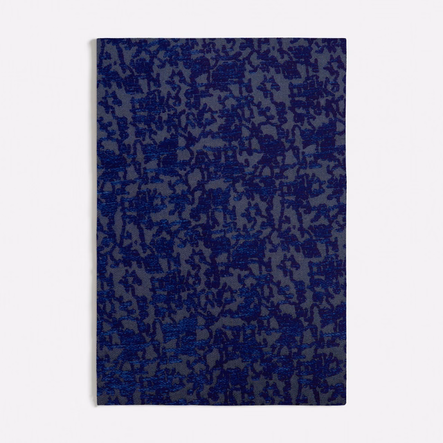 Deep ink-blue swatch with dense irregular botanical marks and a tactile woven ground