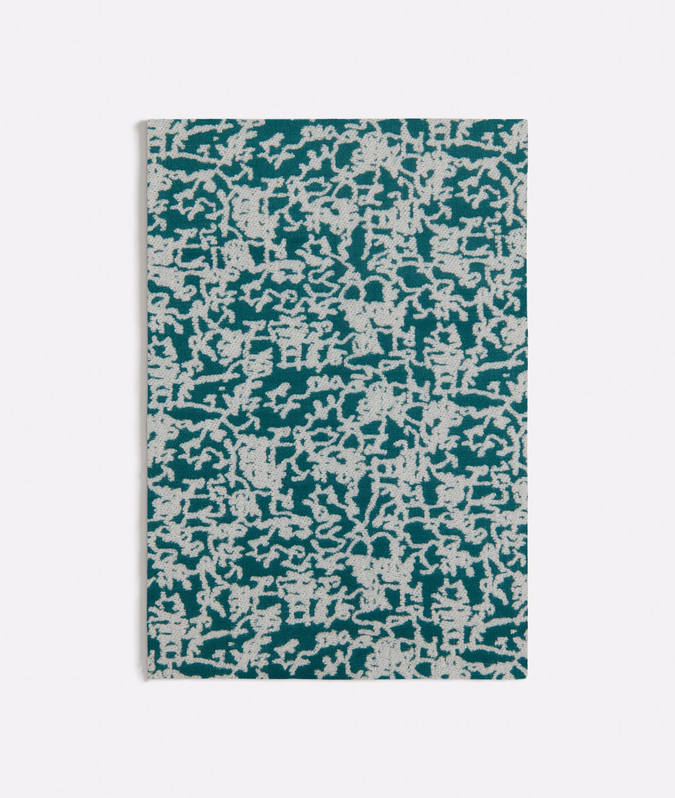 Deep teal textile with dense ivory branching marks and a tactile irregular weave