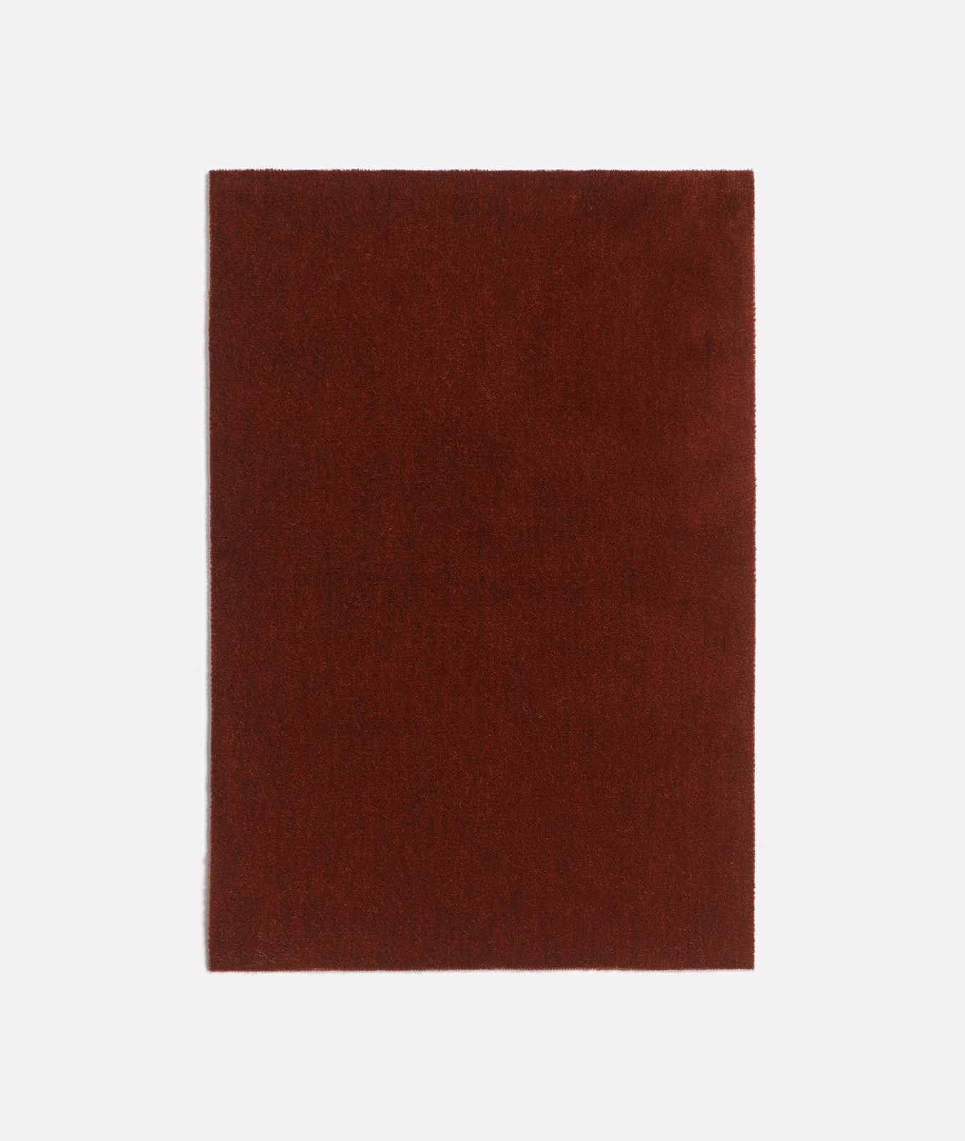 Deep terracotta velvet swatch showing subtle nap variation and directional sheen