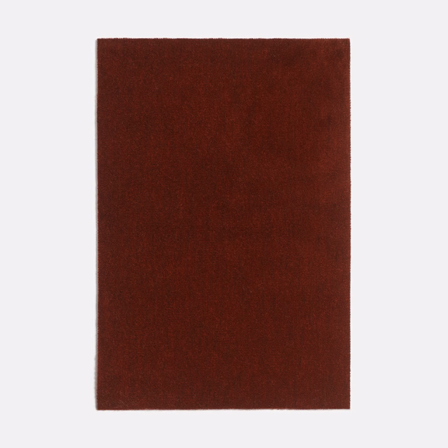 Deep terracotta velvet swatch showing subtle nap variation and directional sheen