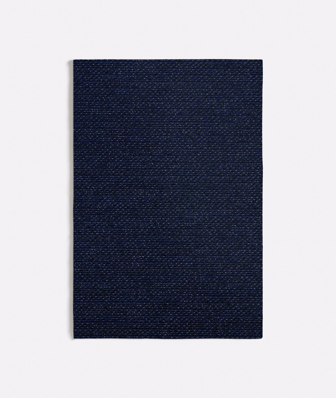 Close view of dense midnight-blue weave with fine lighter flecks across the surface