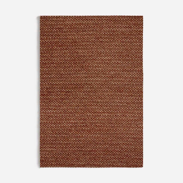 Dense terracotta woven textile with tiny looped texture and warm rust-brown shading