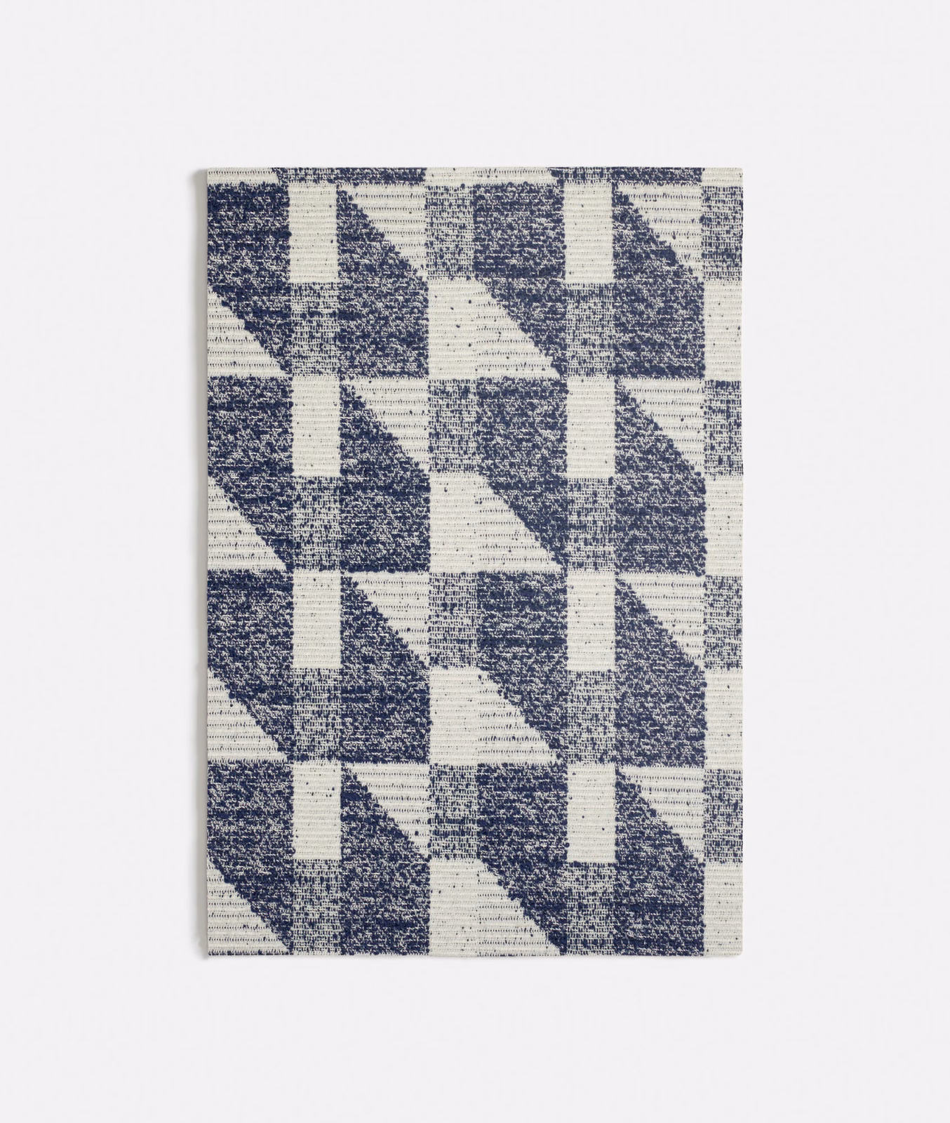 Navy and ivory woven fabric with repeating triangular geometric blocks and ribbed texture