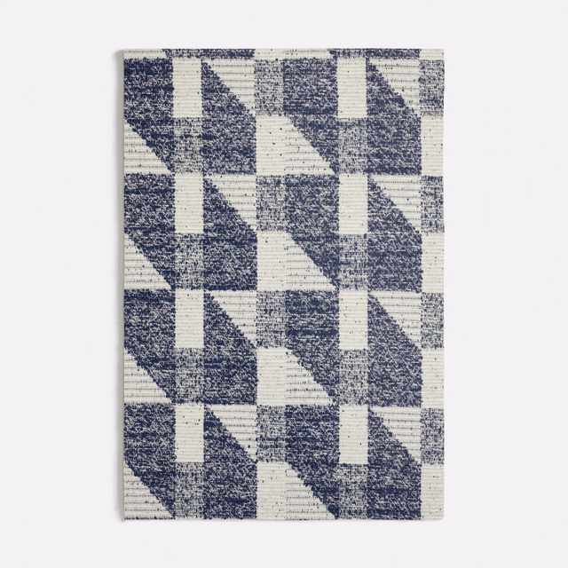 Navy and ivory woven fabric with repeating triangular geometric blocks and ribbed texture