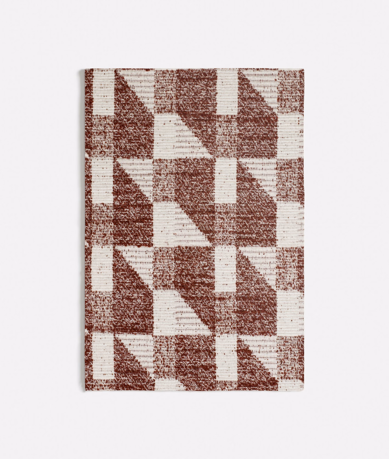 Warm terracotta and ivory geometric woven blocks with a softly flecked surface