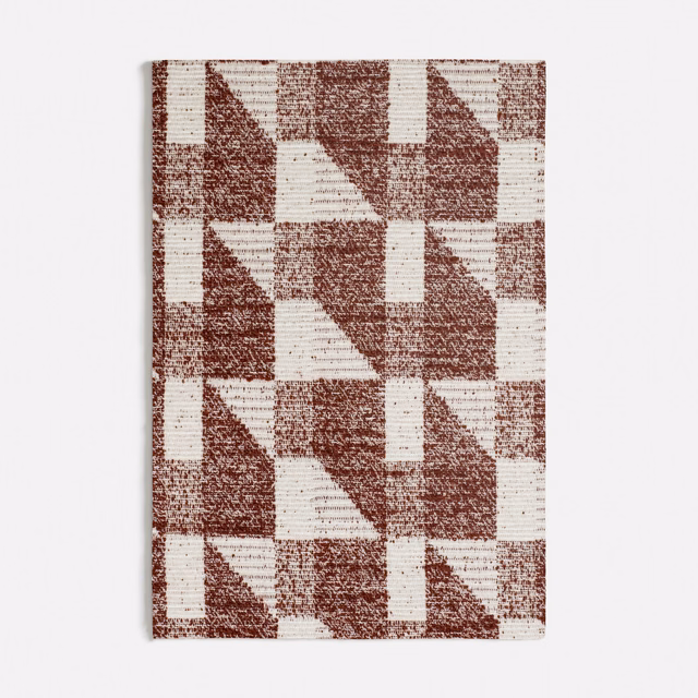 Warm terracotta and ivory geometric woven blocks with a softly flecked surface