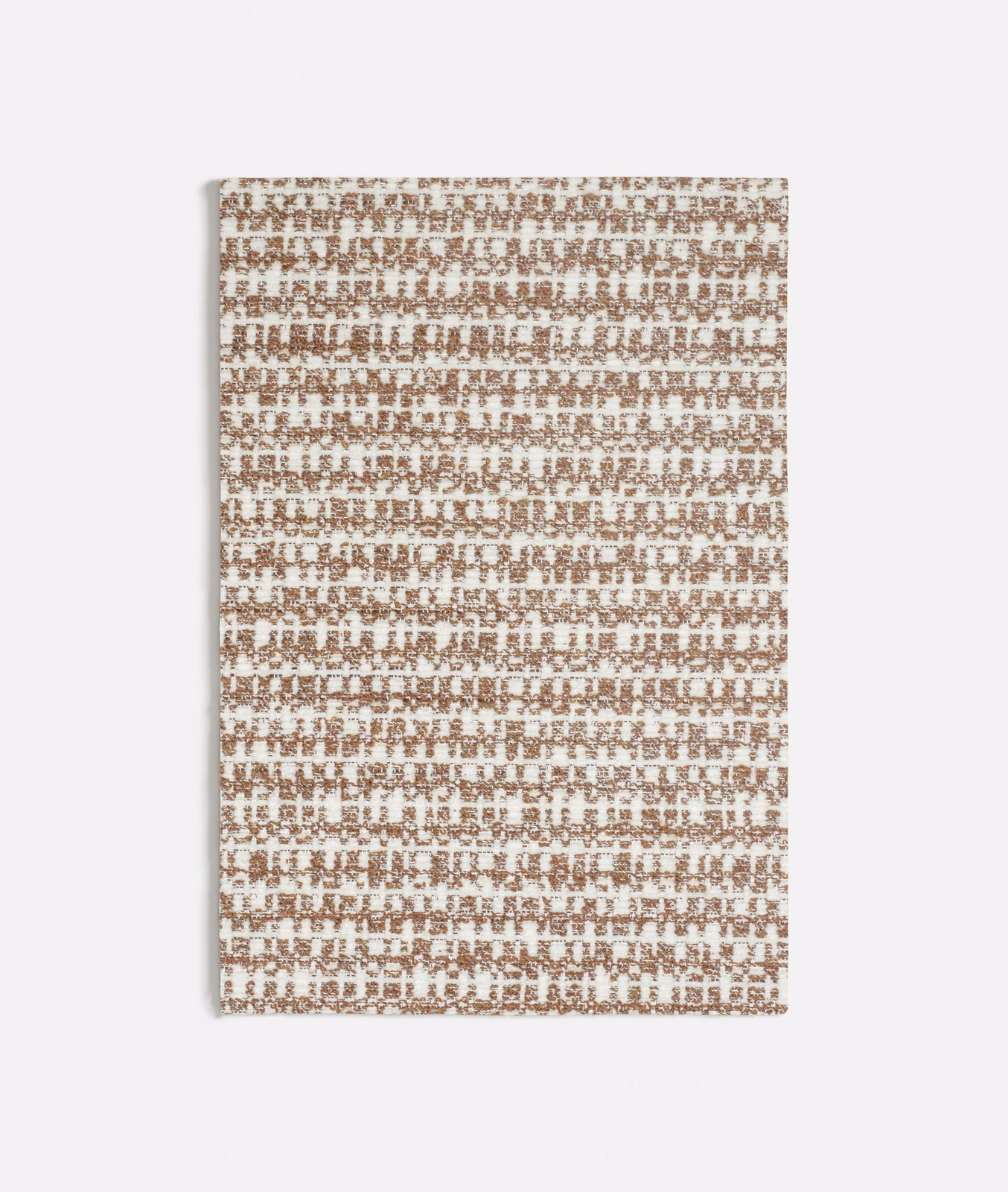 Muted terracotta and ivory woven textile with a small broken grid texture