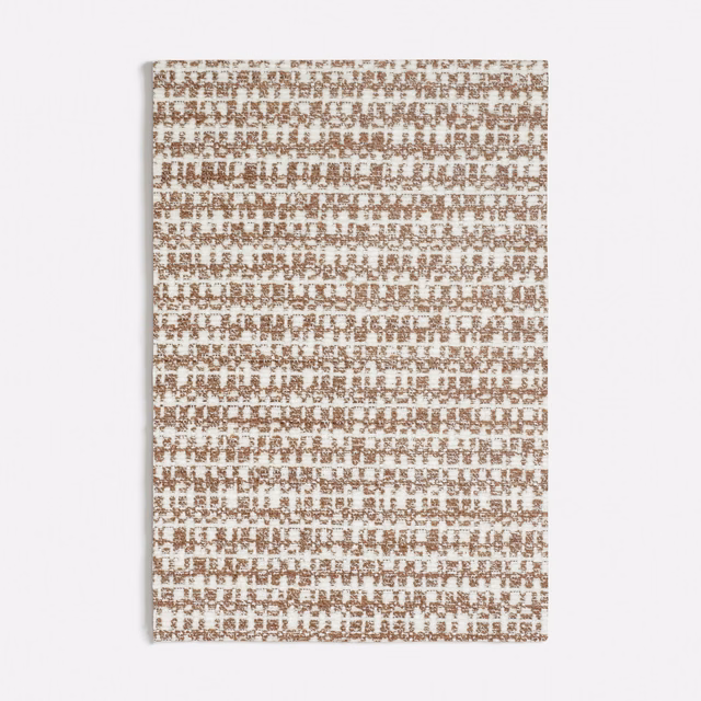 Muted terracotta and ivory woven textile with a small broken grid texture