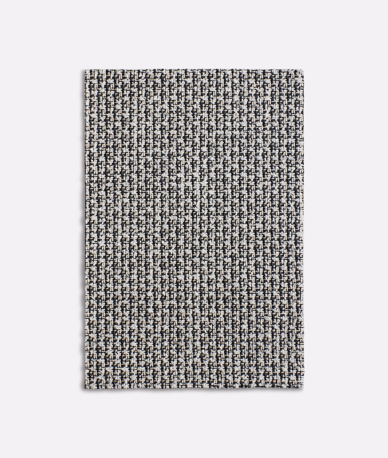 Close view of Carillon Black’s black-and-ivory flecked woven textile with vertical texture.
