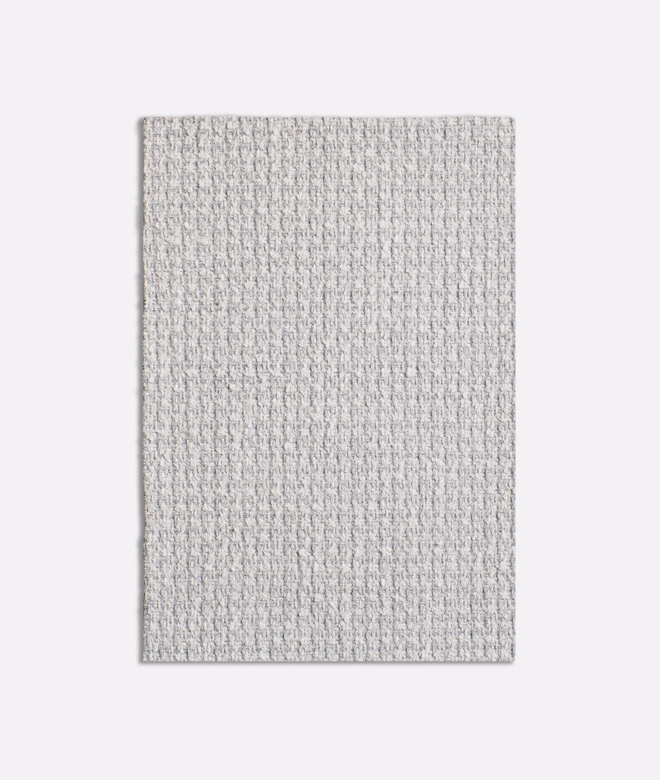 Close-up of pale cool grey fabric with a fine nubby woven texture