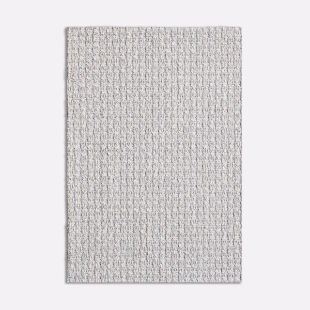 Close-up of pale cool grey fabric with a fine nubby woven texture