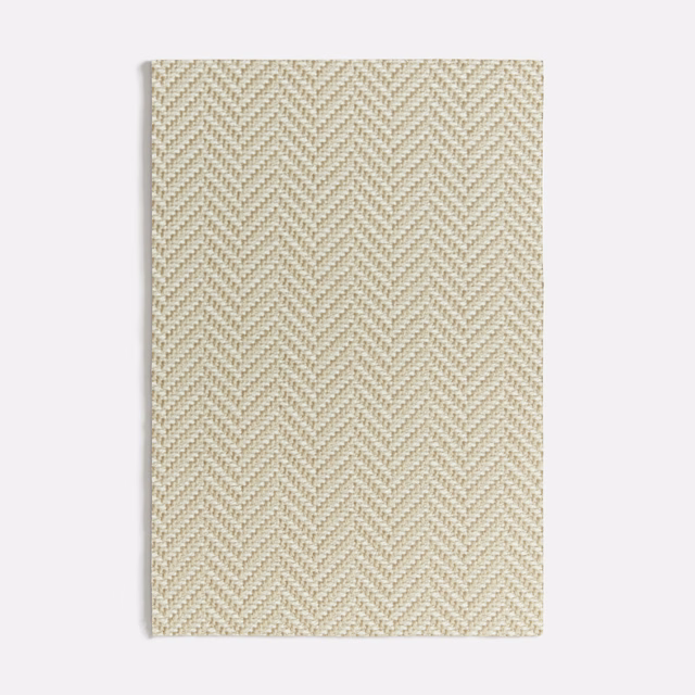 Pale warm-beige fabric swatch with a fine raised herringbone weave and subtle tonal flecks