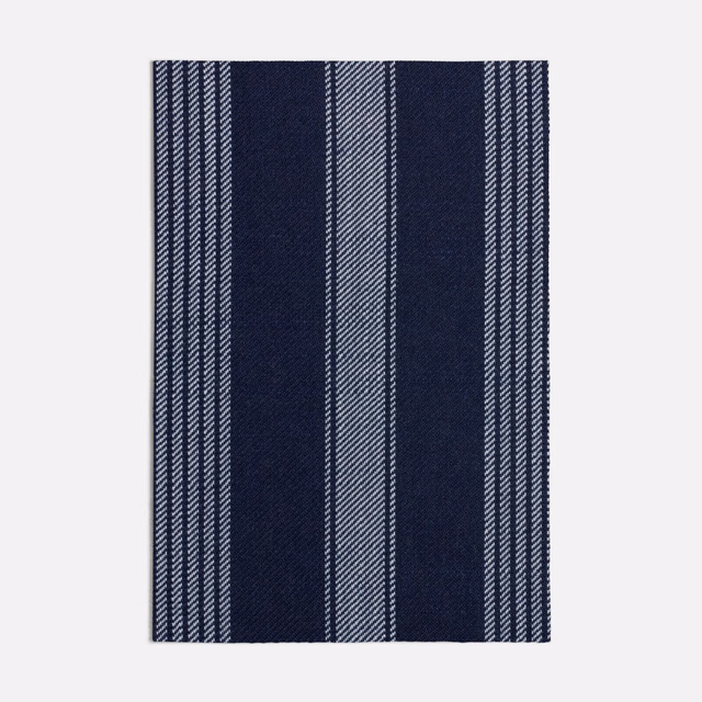 Deep ink-blue woven swatch with pale blue-grey vertical stripes and broad bands