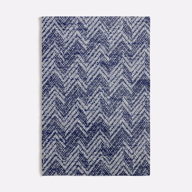Ink-blue and ivory zigzag chevrons in a closely textured woven surface