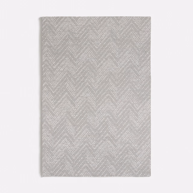 Pale cool grey fabric swatch with fine woven chevron texture