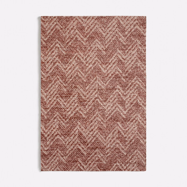 Terracotta woven fabric with pale flecked chevron zigzags and tactile texture