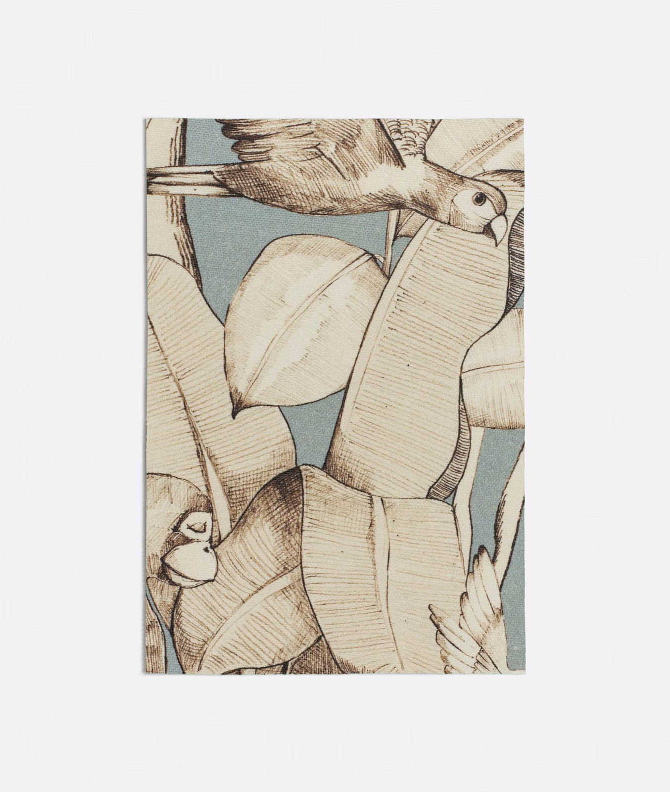 Cool seafoam fabric with cream leaves, brown linework and a perched bird