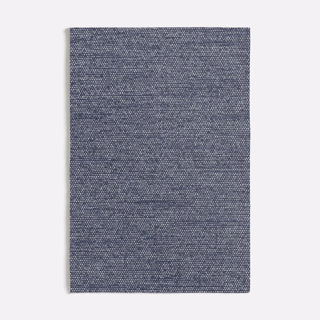 Muted blue-grey Corbello swatch showing a compact, subtly mottled woven texture