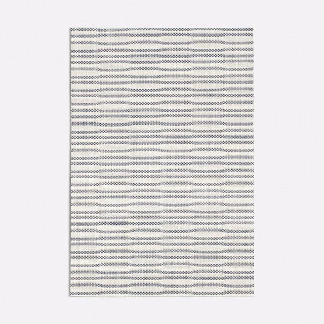 Pale blue-grey textile with fine woven texture and irregular horizontal wave lines