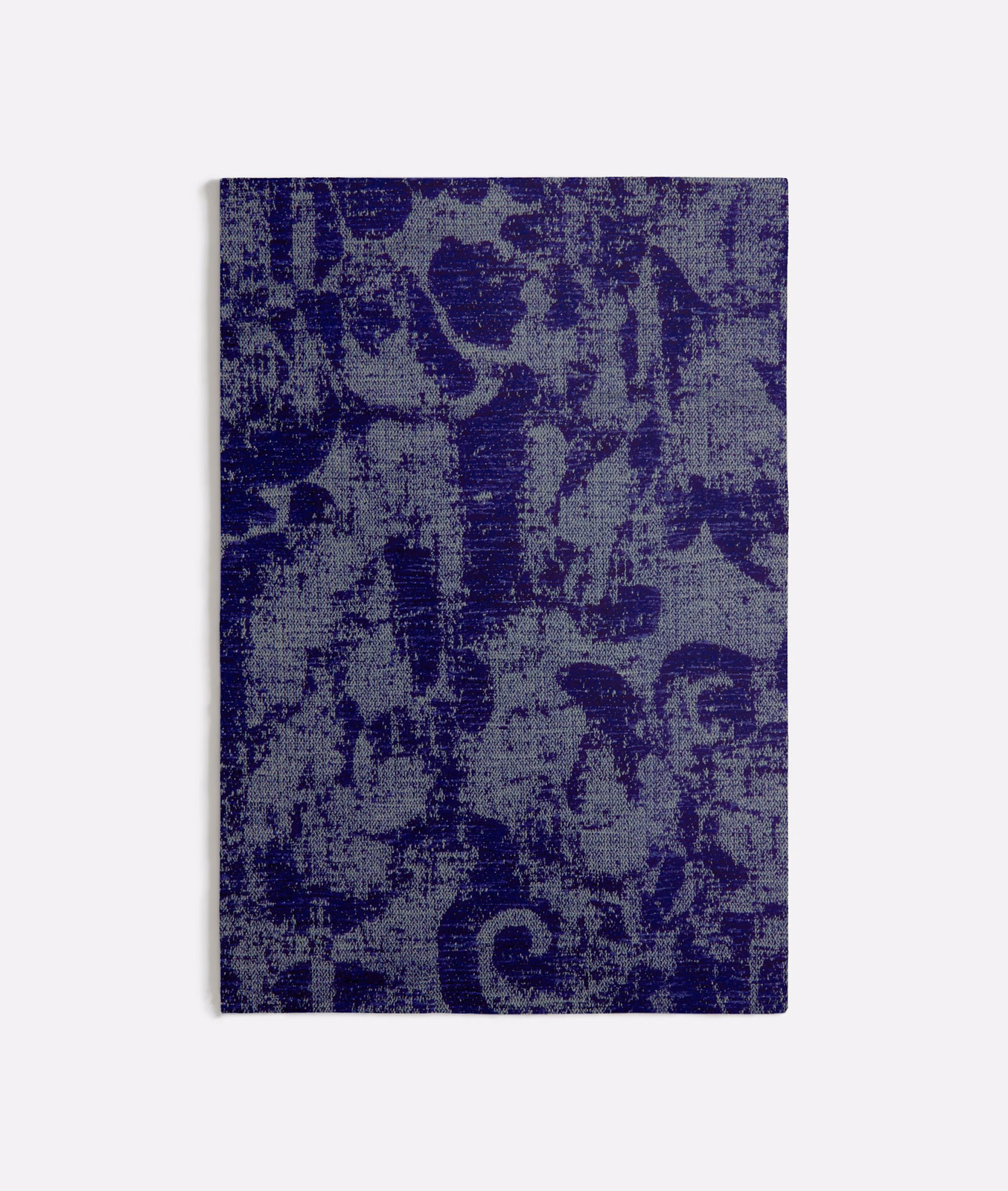 Deep indigo woven fabric with distressed blue-violet abstract botanical marks