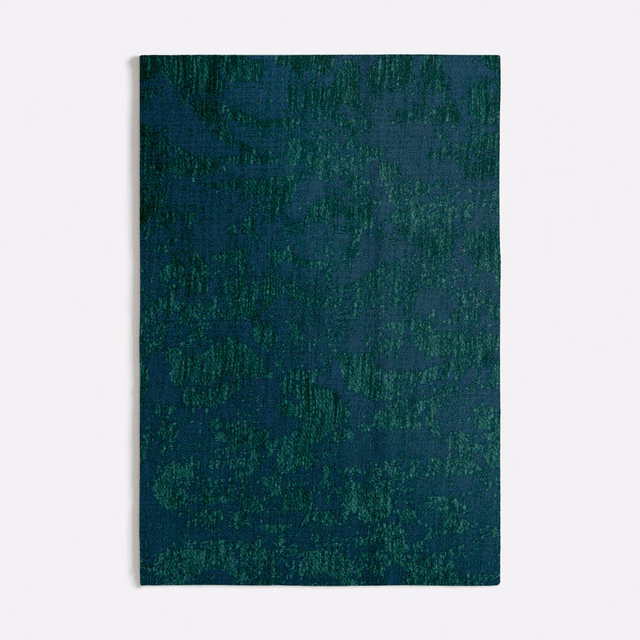 Deep teal seafoam textile with mottled green abstract texture and dense woven grain