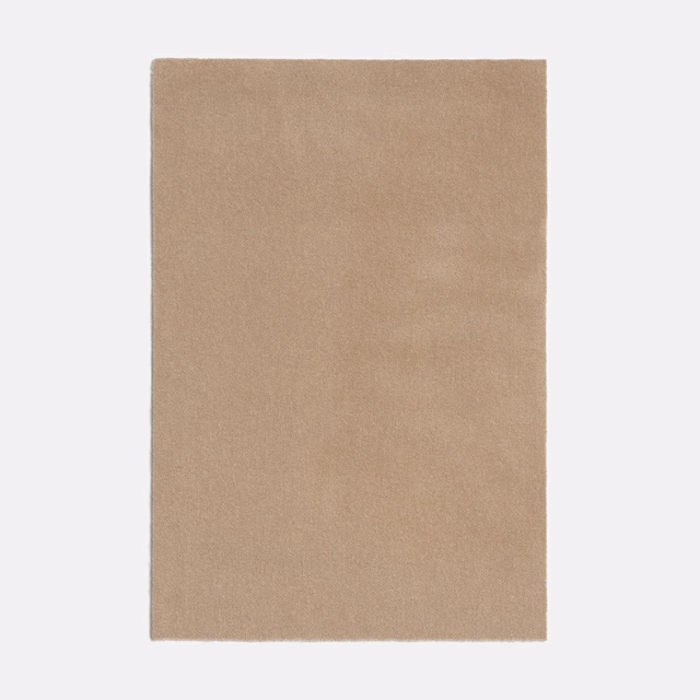 Warm oat-beige plain fabric with a fine, softly mottled woven surface