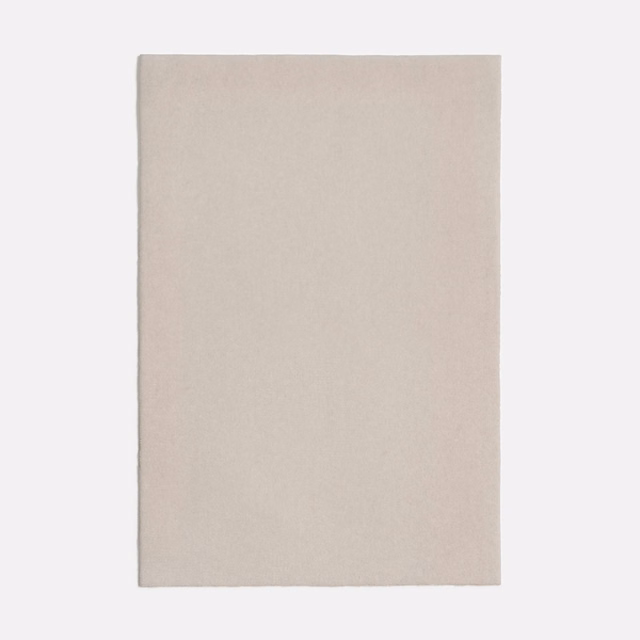 Warm off-white Dedar fabric with a subtle, even surface texture