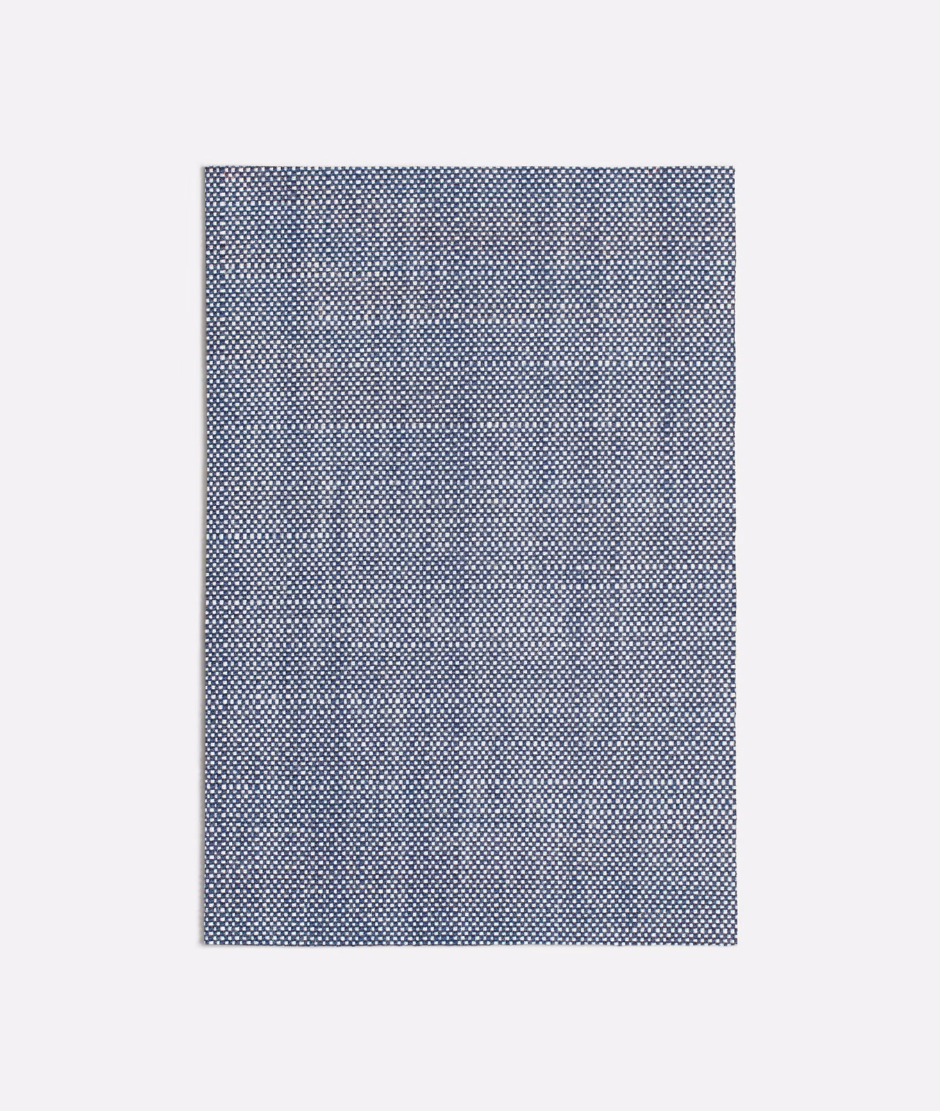 Close view of cool slate blue-grey fabric with a fine geometric woven texture