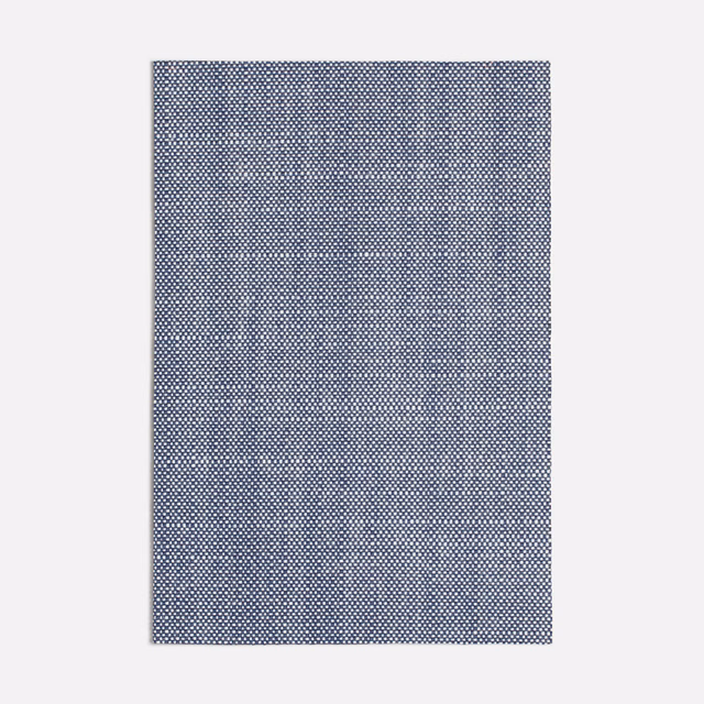 Close view of cool slate blue-grey fabric with a fine geometric woven texture
