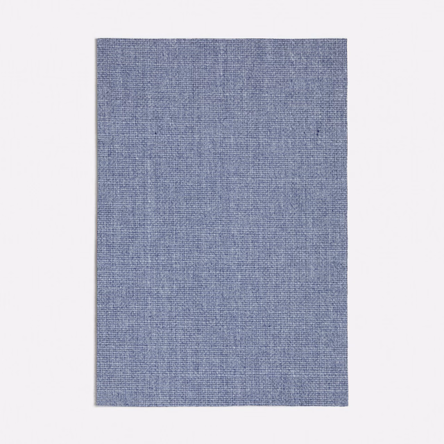 Close-up of muted blue-grey Erfoud fabric with a fine plain woven texture