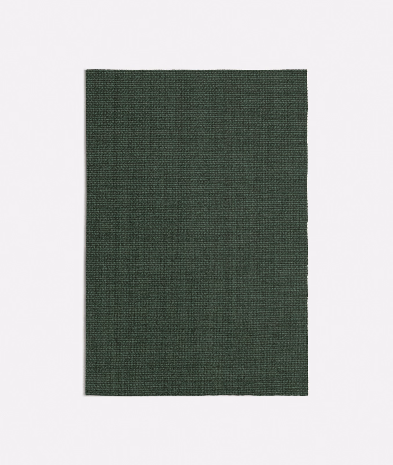 Close view of deep forest green fabric with a fine tonal woven texture