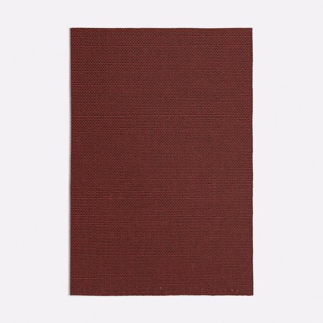 Deep oxblood red fabric swatch showing a fine, tightly woven textured surface
