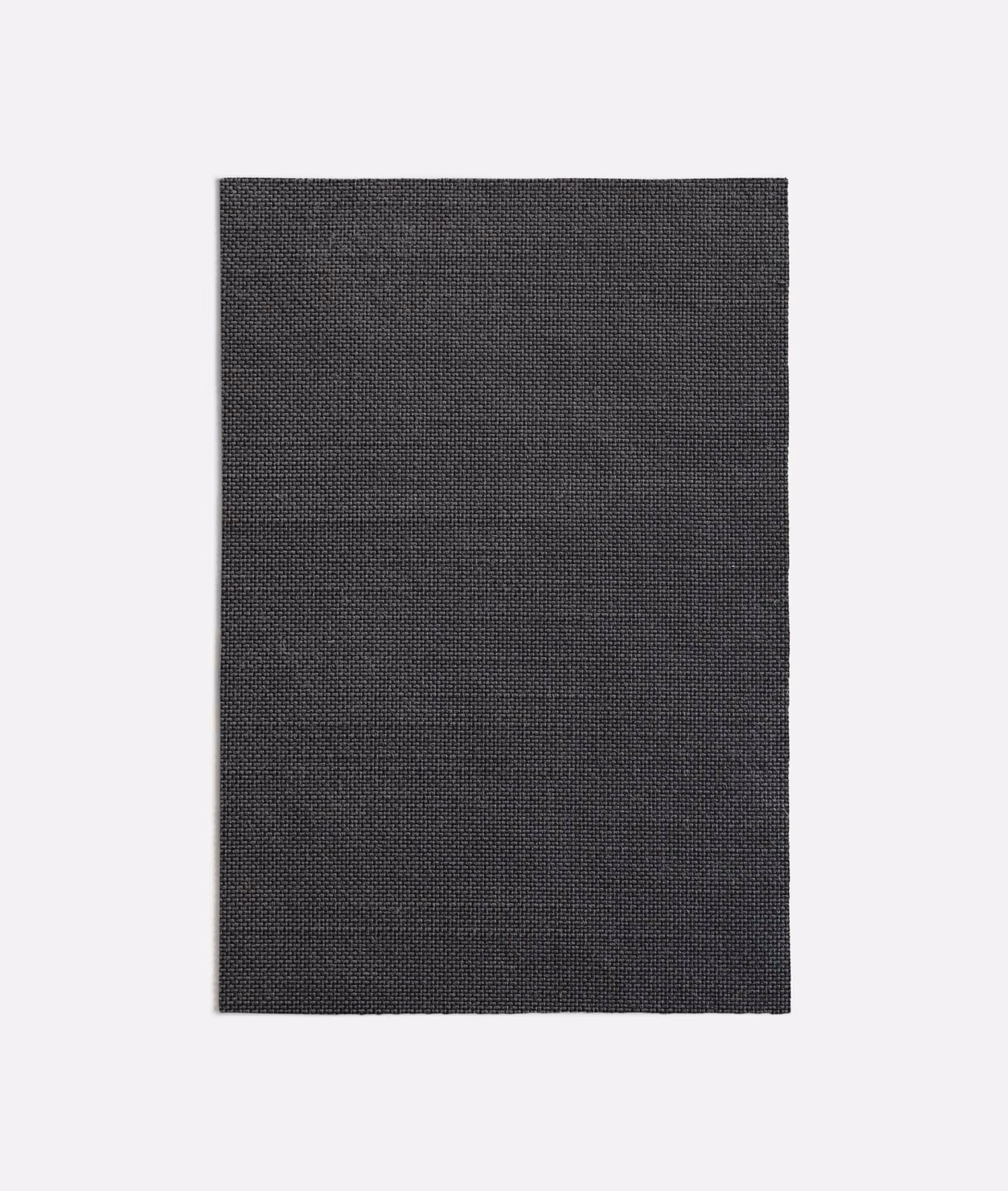 Close-up of dark charcoal-grey fabric with a fine, tightly packed woven grid