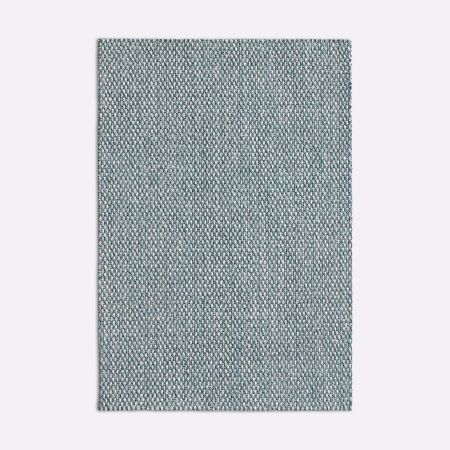 Close-up of cool seafoam green fabric with a dense, pebbled woven texture