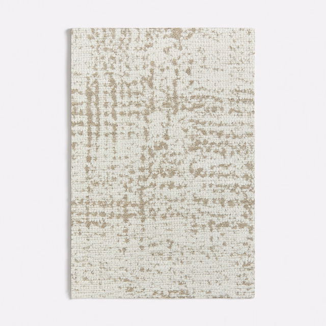 Pale beige woven swatch with irregular taupe mottling and a softly textured grid