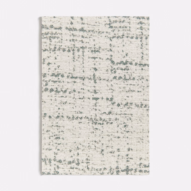 Pale cream woven fabric with mottled seafoam-green horizontal flecks and soft texture