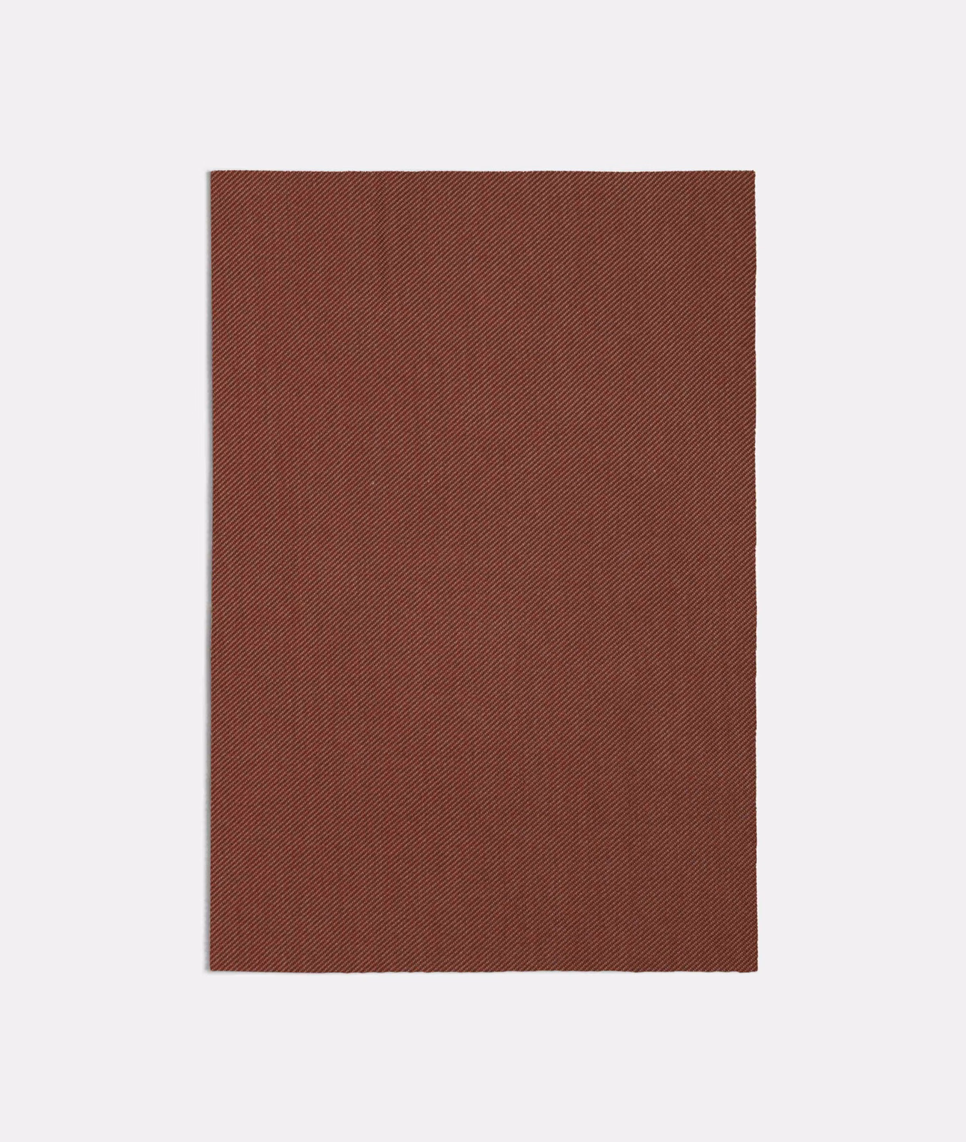 Deep russet-pink fabric swatch showing a fine, closely spaced diagonal weave