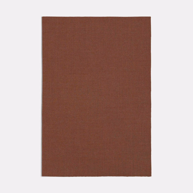 Warm terracotta-brown fabric swatch showing a fine, tight plain weave