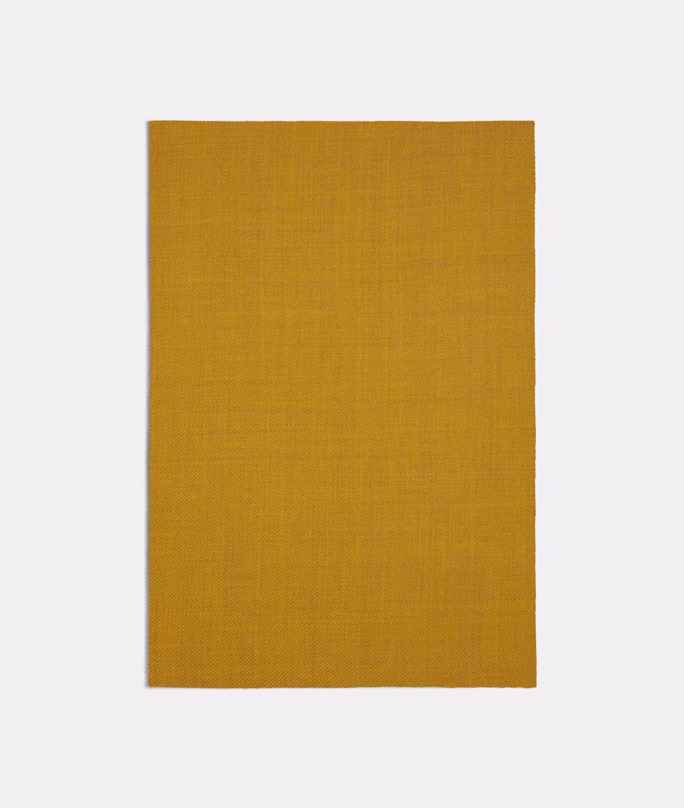 Close view of finely woven ochre-gold textile with subtle grid texture