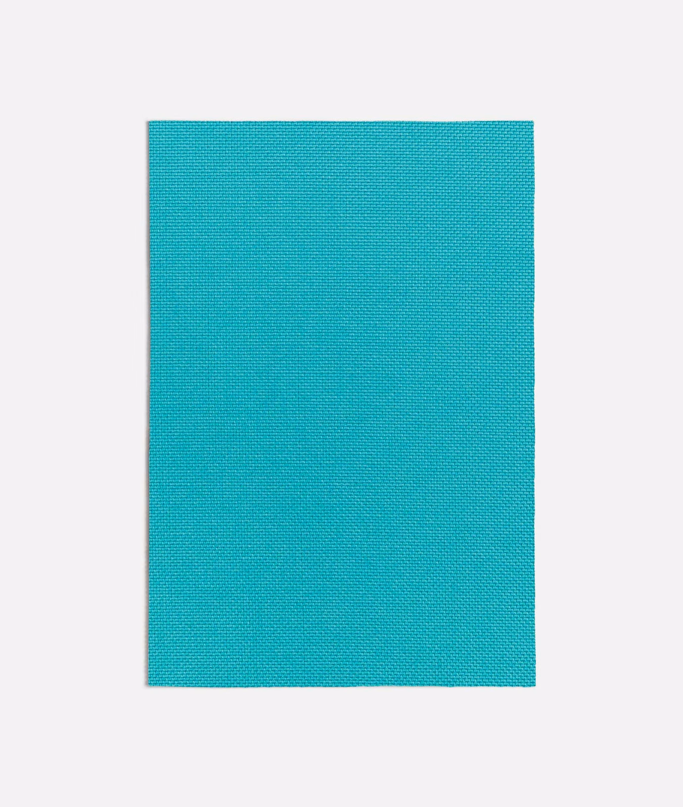 Close-up of saturated turquoise fabric with a fine, tightly woven plain texture