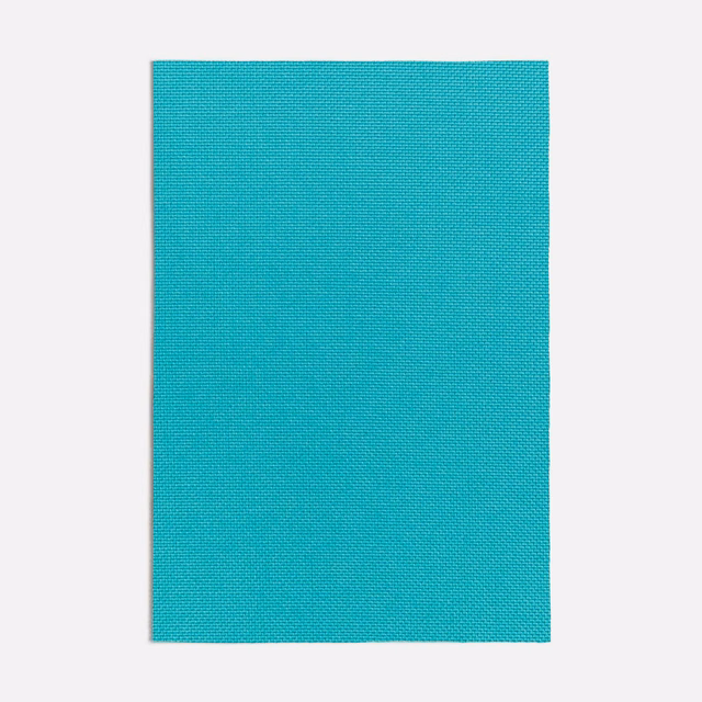 Close-up of saturated turquoise fabric with a fine, tightly woven plain texture